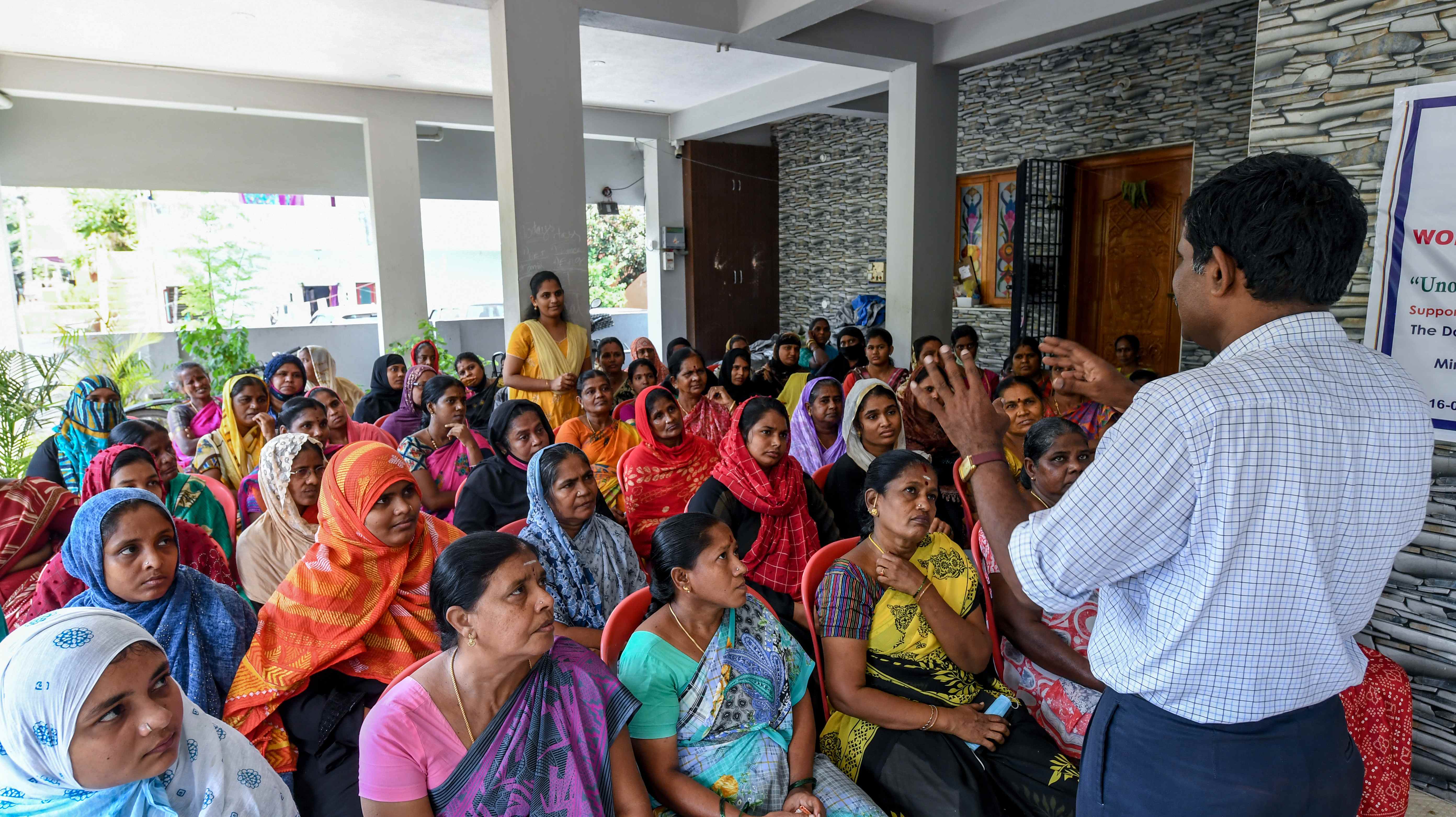 Women's empowerment meeting showing a group of women engaged in community discussion